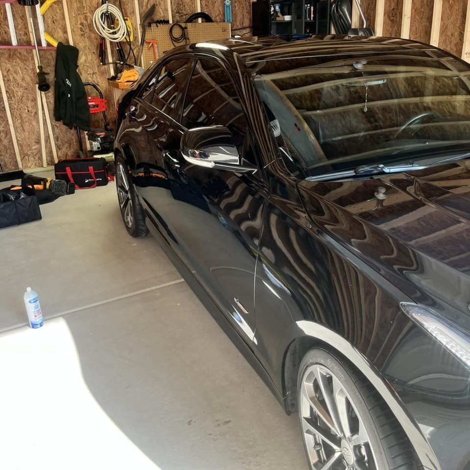 Dark sedan with a mirror-like detailed finish